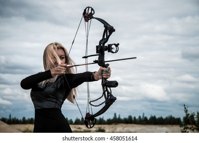 Young woman with a compound bow