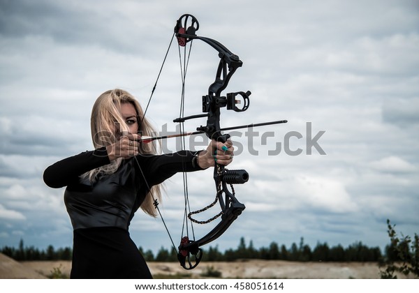 Young woman with a compound\
bow