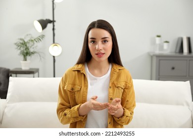 Young Woman Conducting Webinar In Room At Home