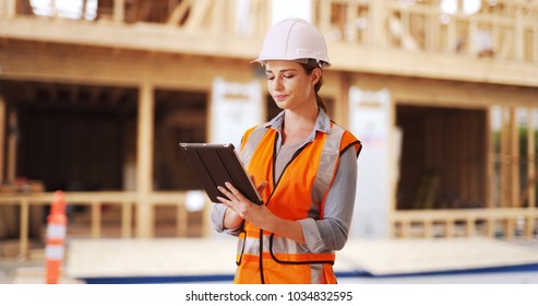 Young Woman Construction Manager Directing Traffic In Front Of Project