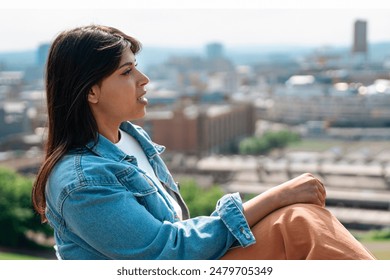 Young Woman Contemplating Cityscape on Sunny Day - Powered by Shutterstock