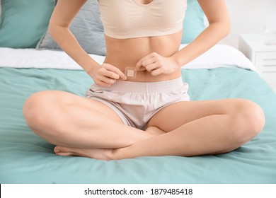 Young Woman With Contraceptive Patch In Bedroom