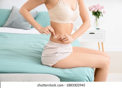 Young Woman With Contraceptive Patch In Bedroom