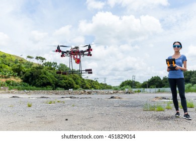 Young Woman Control Drone Flying At Outdoor