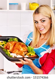 Young Woman Cooking Chicken At Kitchen.