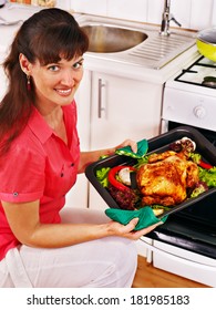 Young Woman Cooking Chicken At Kitchen.