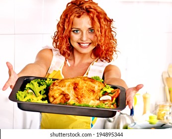 Young Woman Cooking Chicken At Kitchen.