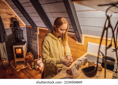 Young Woman Cooking Food Whilst Glamping. Rest In The Mountains In Glamping. Cozy Fireplace In A Mountain House