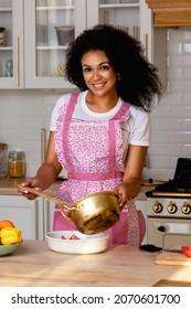 
Young Woman Cooking In The Kitchen