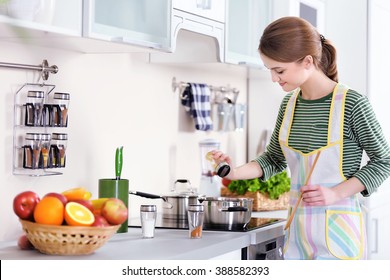 Young Woman Cooking In The Kitchen