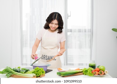 Young Woman Cooking in the kitchen. Healthy Food. Dieting Concept. Healthy Lifestyle. Cooking At Home. Prepare Food - Shutterstock ID 1091099510