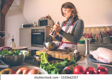 Young Woman Cooking In The Kitchen. Healthy Food For Christmas (stuffed Duck Or Goose)