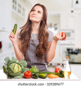 Young Woman Cooking in the kitchen. Healthy Food - Vegetable Salad. Diet. Dieting Concept. Healthy Lifestyle. Cooking At Home. Prepare Food  - Shutterstock ID 329289677