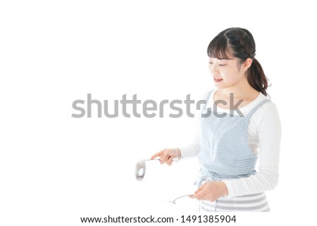 Young woman cooking something with smile