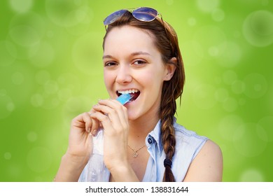 Young Woman Cooling Off Eating Popsicle During Summer