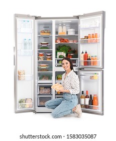 Young Woman With Corn Near Open Refrigerator On White Background