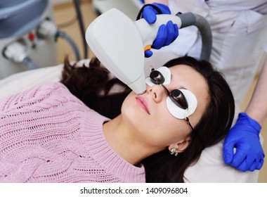 A Young Woman In A Cosmetic Clinic On The Procedure Of Hair Removal Over The Upper Lip. Laser Hair Removal