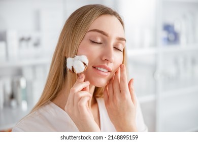 Young Woman With Cotton Plant Standing In Beauty Salon