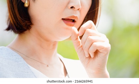 Young Woman Coughing Outdoors During The Day