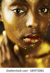 Young Woman Covered in Gold glitter