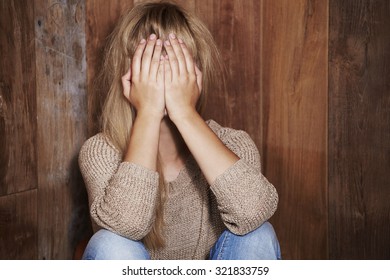 Young Woman Covering Face With Hands