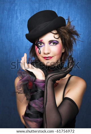 Young woman with creative visage in vintage hat and black glove