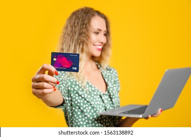 Young Woman With Credit Card And Laptop On Color Background