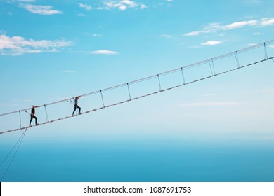 Young Woman Crossing The Chasm On The Rope Bridge. Ai-Petri, Crimea