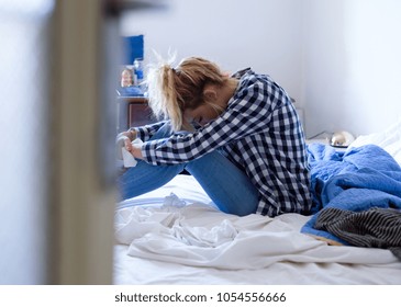  Young woman crying in bed after domestic violence at home - Shutterstock ID 1054556666