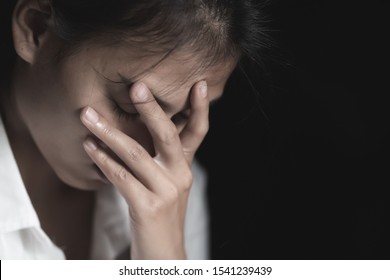 A young woman crying and covering her face. depression or domestic violence. The concept of sexual harassment against women and rape.  human trafficking,  international women's day.
