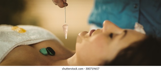 Young Woman At Crystal Healing Session In Therapy Room