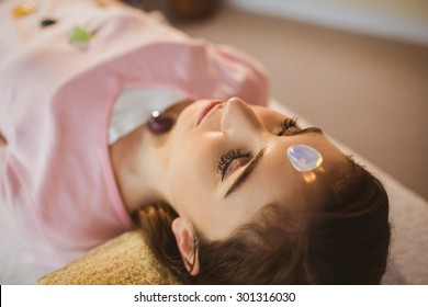 Young Woman At Crystal Healing Session In Therapy Room