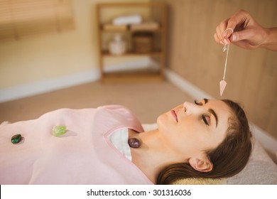 Young Woman At Crystal Healing Session In Therapy Room