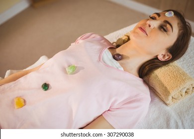 Young Woman At Crystal Healing Session In Therapy Room