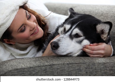 Young Woman Cuddling Her Dog