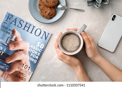 Young Woman With Cup Of Delicious Hot Coffee At Table, Top View