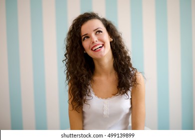 Young Woman With Curly Hair Smiling