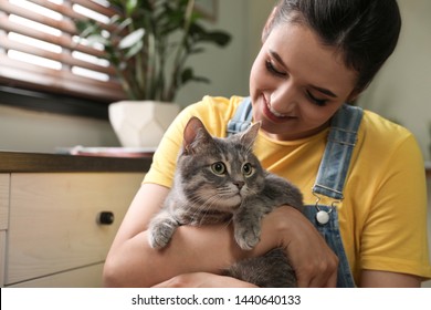 Young Woman With Cute Cat At Home. Pet And Owner