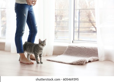 Young Woman With Cute Cat At Home