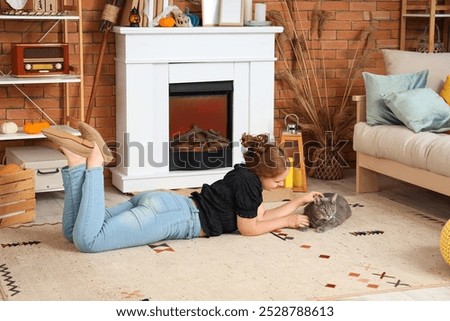 Similar – Mother hugging her baby in front of fireplace