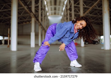 Young  woman - dancer dancing  in the underpass. Sport, dancing and urban culture concept.