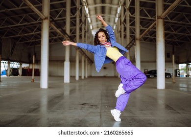 Young  woman - dancer dancing  in the underpass. Sport, dancing and urban culture concept.
