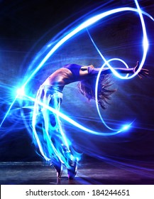 Young Woman Dancer. With Light Effects.