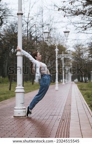 Similar – beautiful young woman having fun outside in park