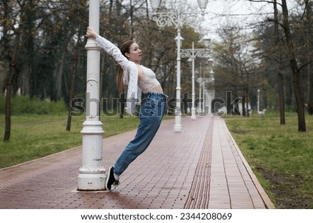 Similar – beautiful young woman having fun outside in park