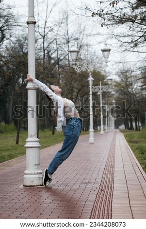 Similar – beautiful young woman having fun outside in park