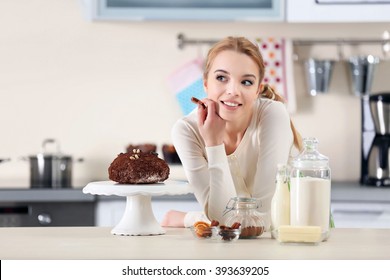 Young Woman Decorating Cake With Chocolate