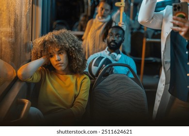 A young woman, deep in thought, leans against the window during a nighttime bus commute, reflecting on her day. - Powered by Shutterstock