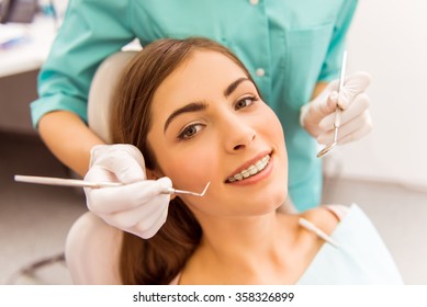 Young Woman Dentist Examines The Teeth Of His Patient