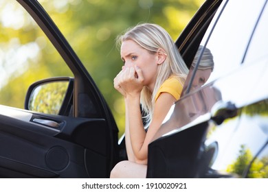 young woman is depressed in her car